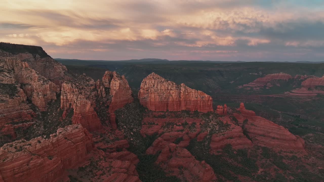 Red Massive Rocky Outcrop Over Cloudy Sky In Sedona, Arizona, USA