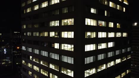 closeup of business office skyscraper in downtown toronto, night aerial