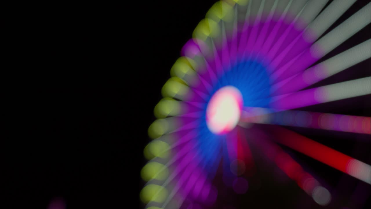 Abstract Bokeh Lights of a Spinning Ferris Wheel at Night