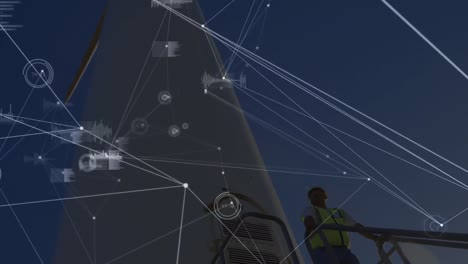 Animation-of-network-of-connections-over-wind-turbine-and-male-engineer-in-background