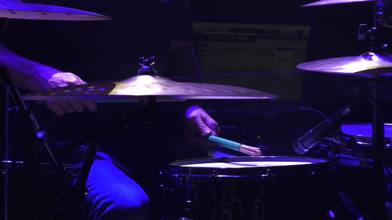 Drummer performing on stage at a concert