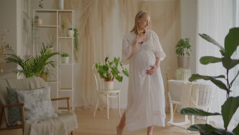 pregnant woman dancing in beautifully decorated room