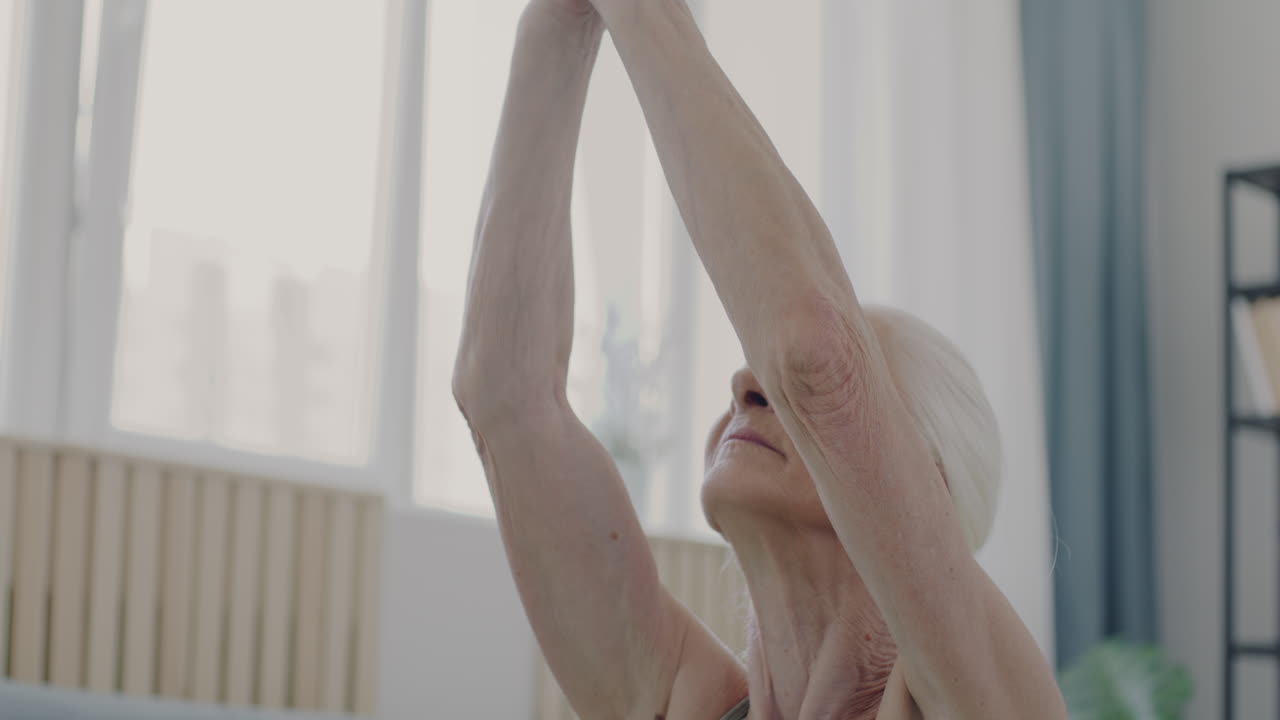 Senior Woman Practicing Yoga at Home
