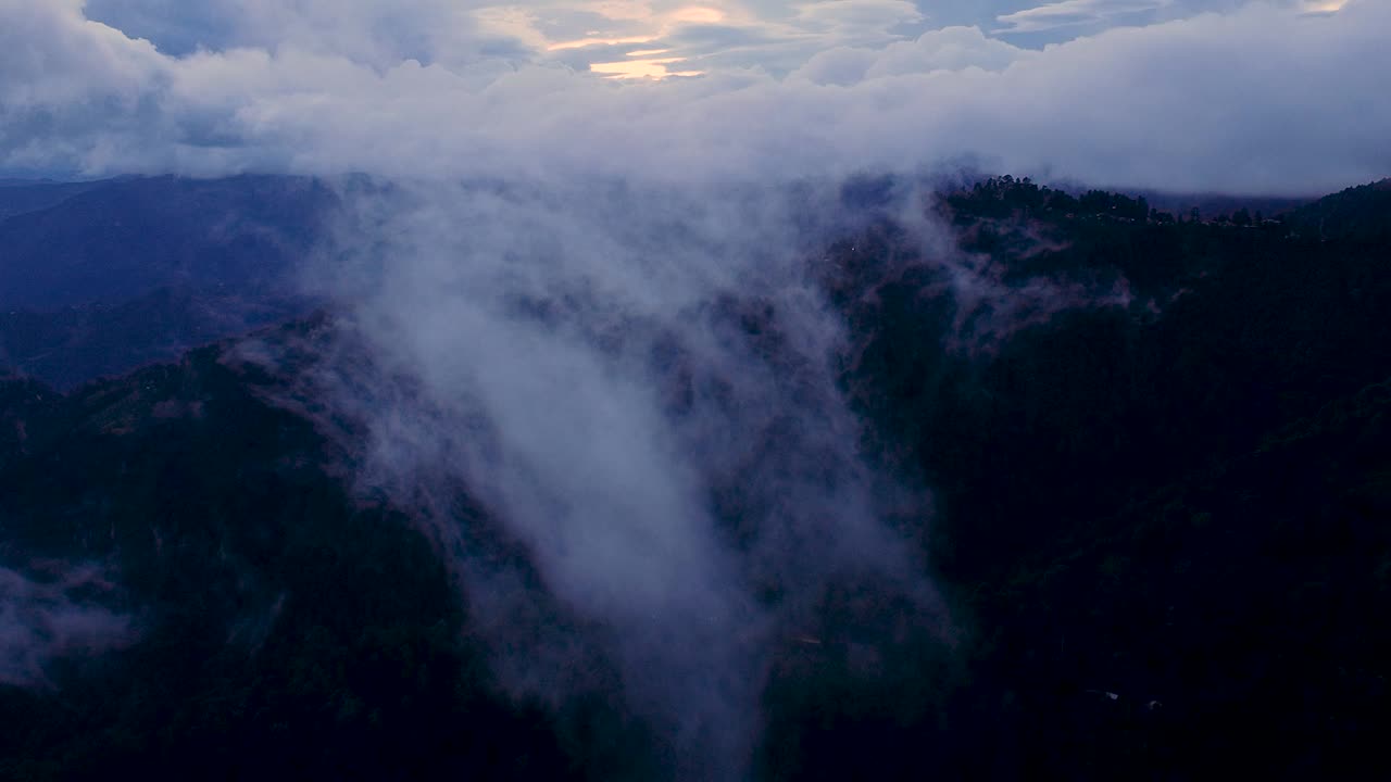Evening Drone Shot of Sierra Peaks with Slowly Disappearing Clouds in San José del Pacífico