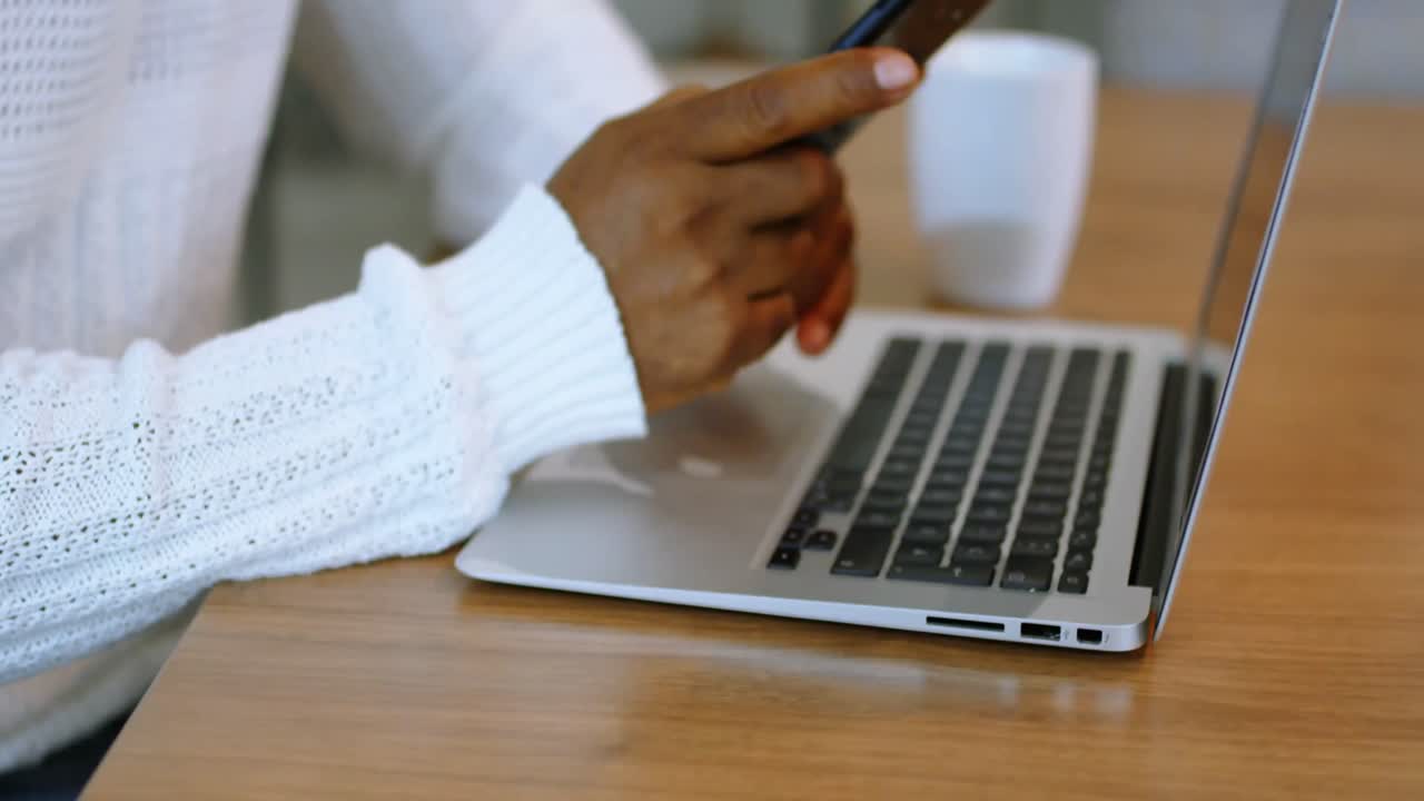 Animation of media icons over african american woman using smartphone