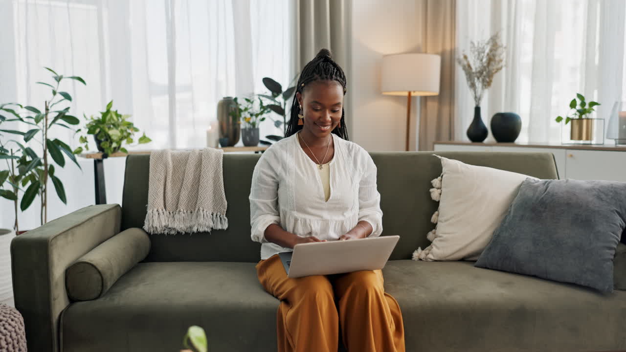 Black woman on sofa, smile