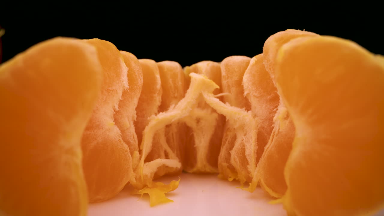 camera removes from set of tasty peeled mandarin wedges