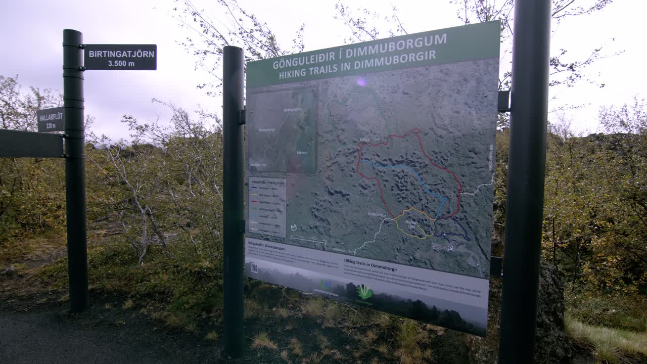 Hiking trail map at Dimmuborgir in Iceland with surrounding nature and directional signs