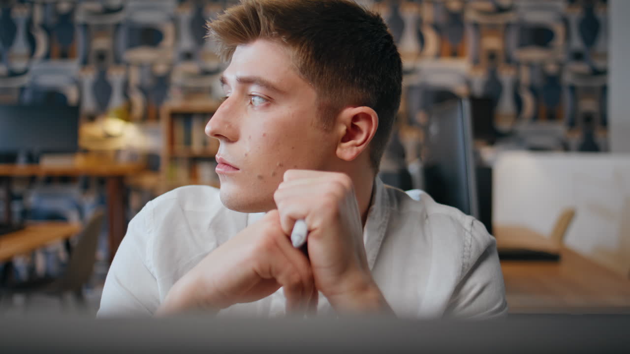 Pensive manager considering decision at workspace closeup. Executive thinking