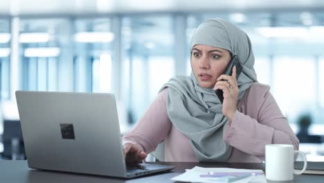 muslim businesswoman talking on phone