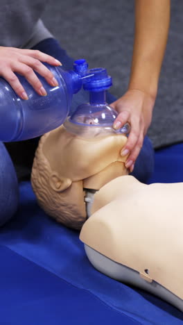 cardiopulmonary resuscitation. instructor demonstrates first aid reanimation on a dummy. medical worker shows cardiac exercise on a mannequin. vertical video