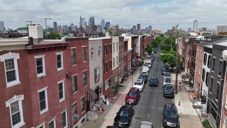 overhead view of a residential street with rowhouses and philadelphia skyline