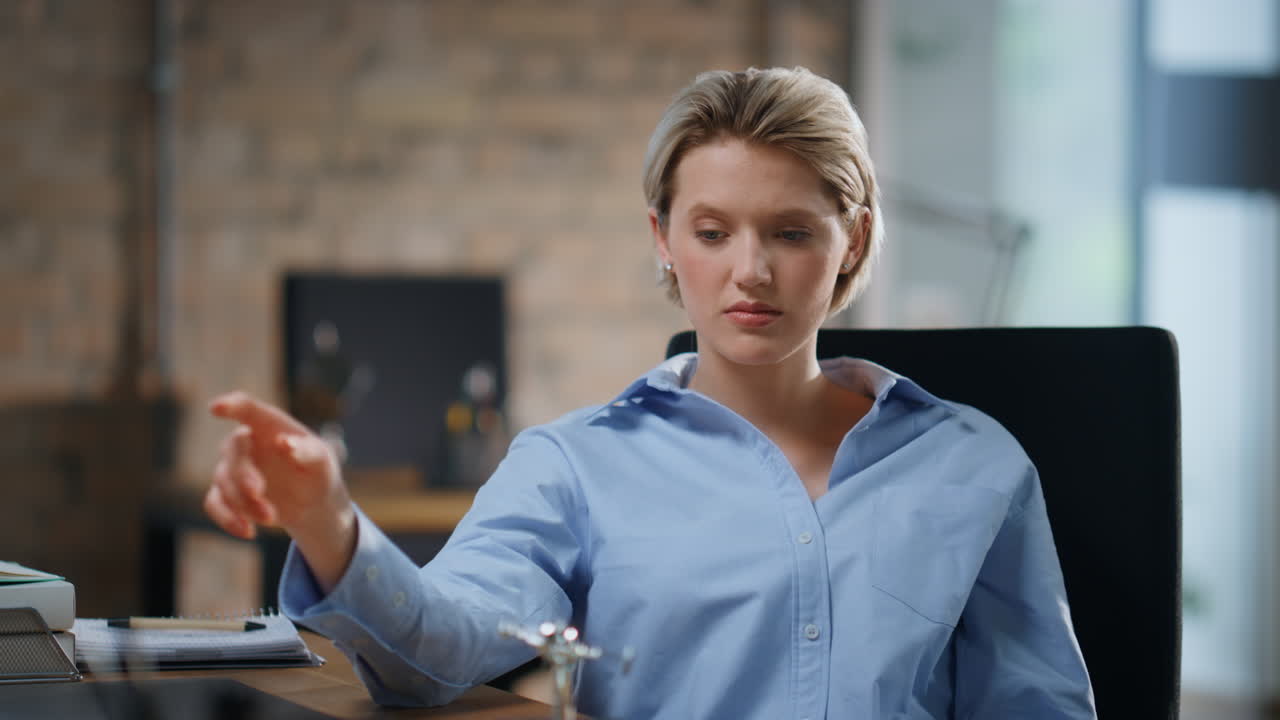 Office manager playing pendulum on table closeup. Businesswoman thinking at work