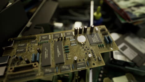 motherboard on workbench surrounded by other electronic components in workshop