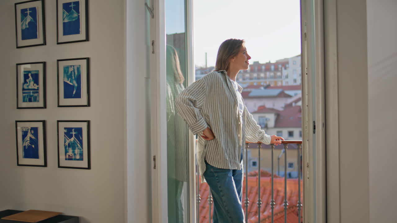 Contemplative woman standing balcony enjoying evening view. Serene girl resting