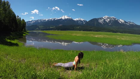 woman practicing yoga in the grassland