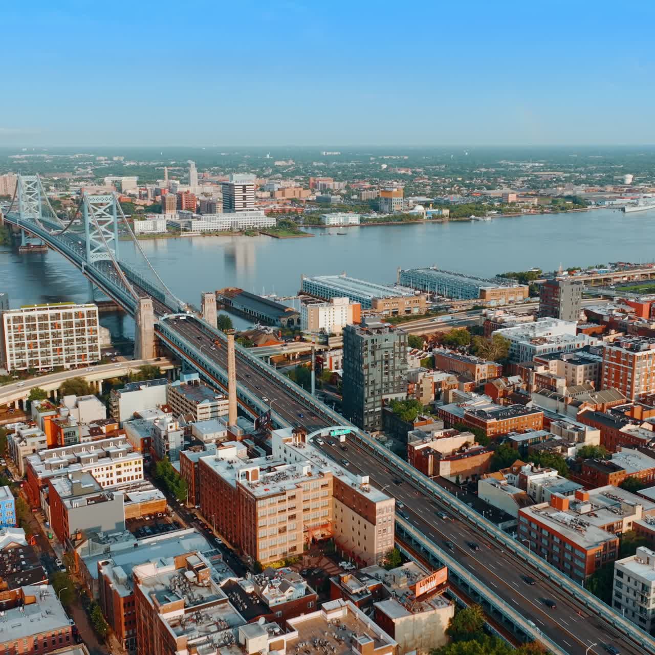 The Ben Franklin Bridge view over the Delaware River in Philadelphia, USA. Beautiful cityscape on sunny day from aerial perspective