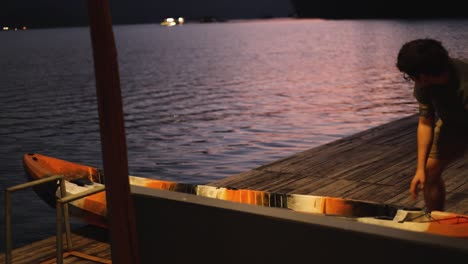 individual readies kayak for a twilight paddle.