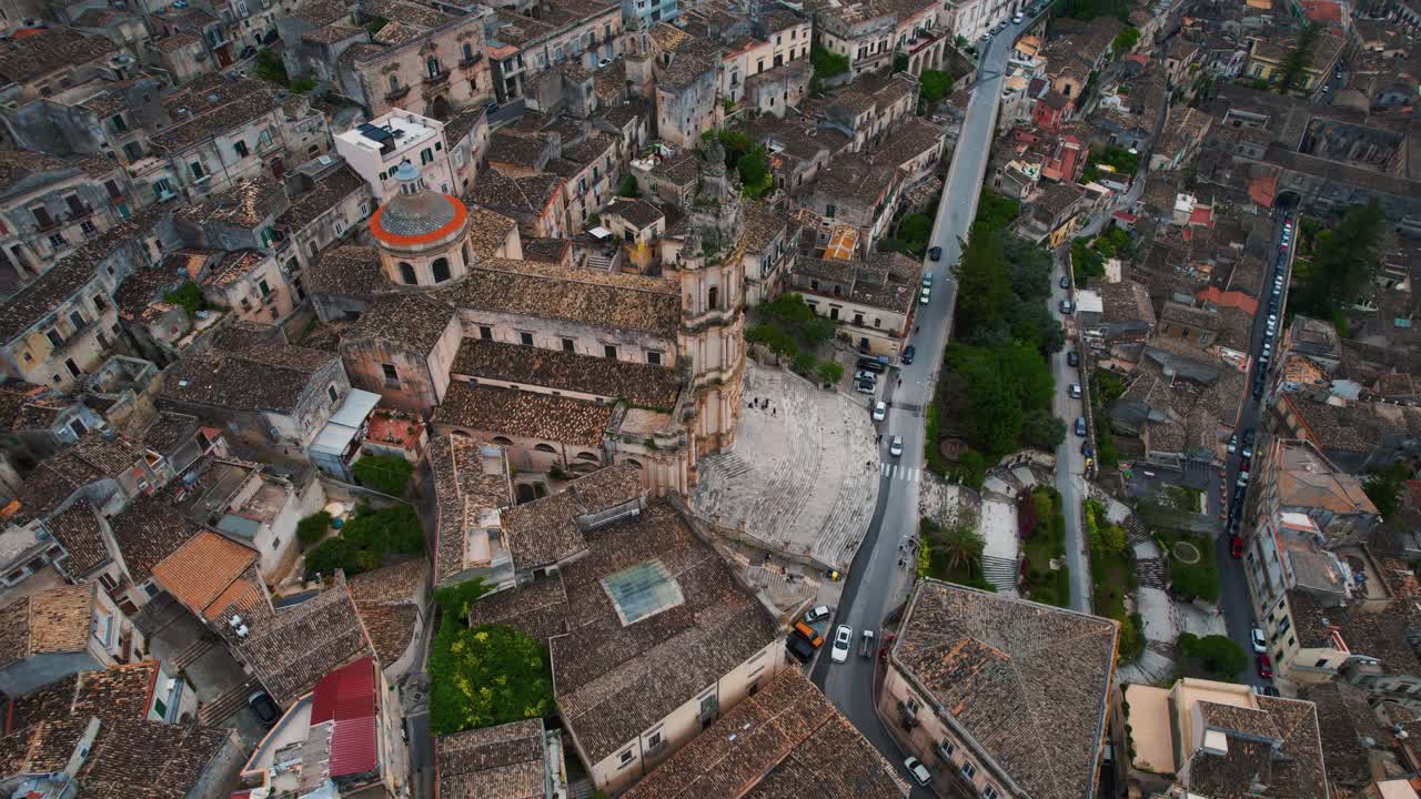 Aerial view of Duomo di San Giorgio rising above Modica. Historic hillside town, Sicily, Italy.