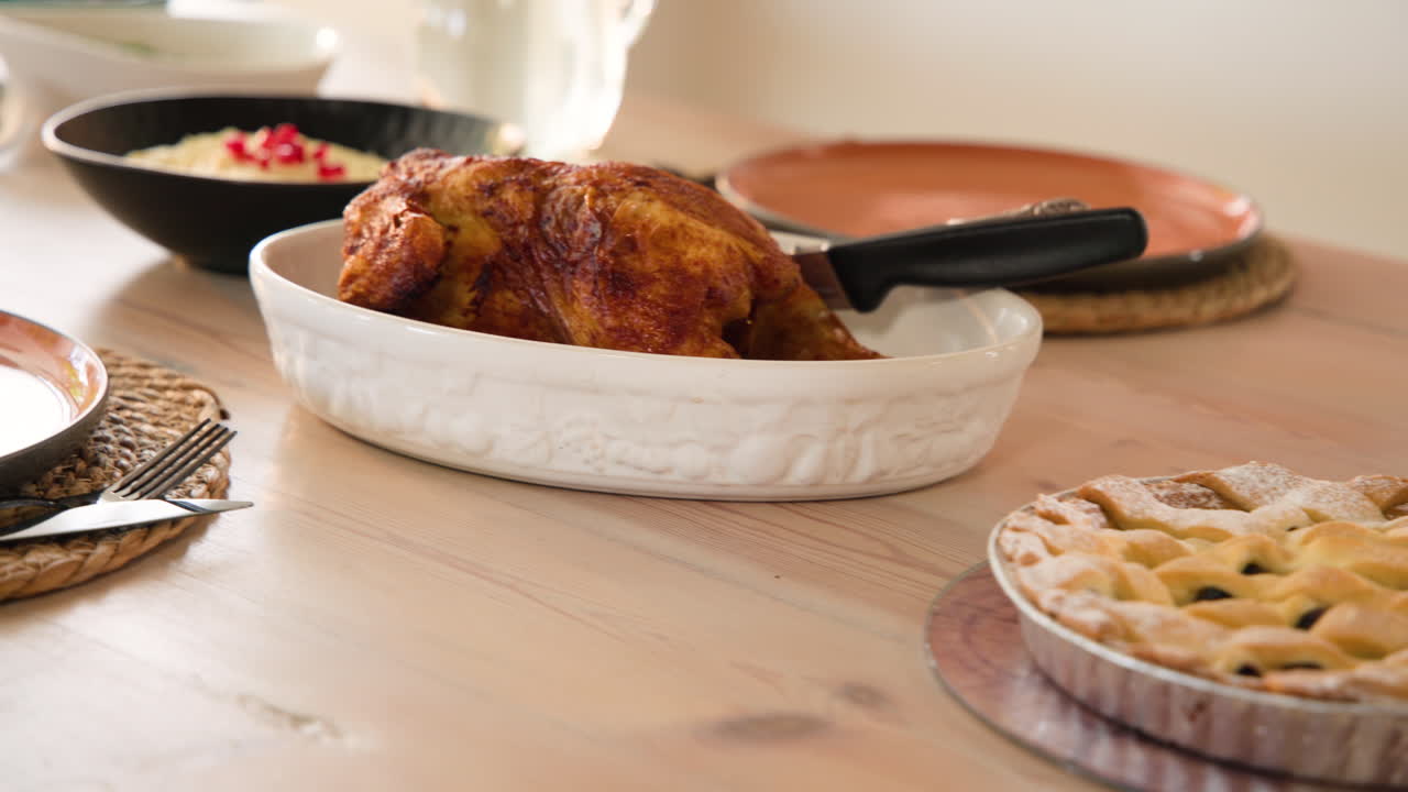 Sunday dinner feast with roasted turkey and apple pie on dining table, at home