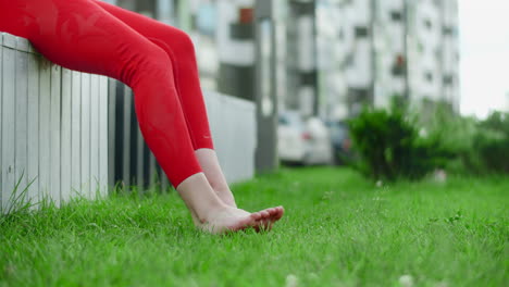 woman relaxing outdoors in red leggings