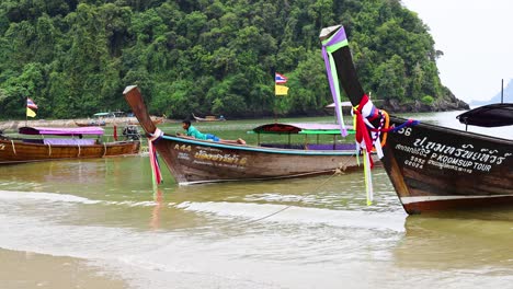 longtail boats at a tropical beach in thailand