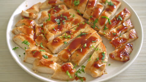 grilled honey chicken breast sliced on white plate