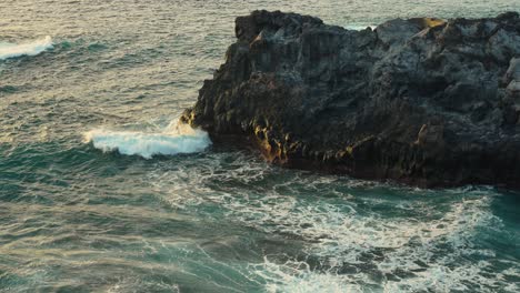 Dreamy-shot-of-waves-crashing-in-slow-motion-at-golden-hour-in-Los-Gigantes