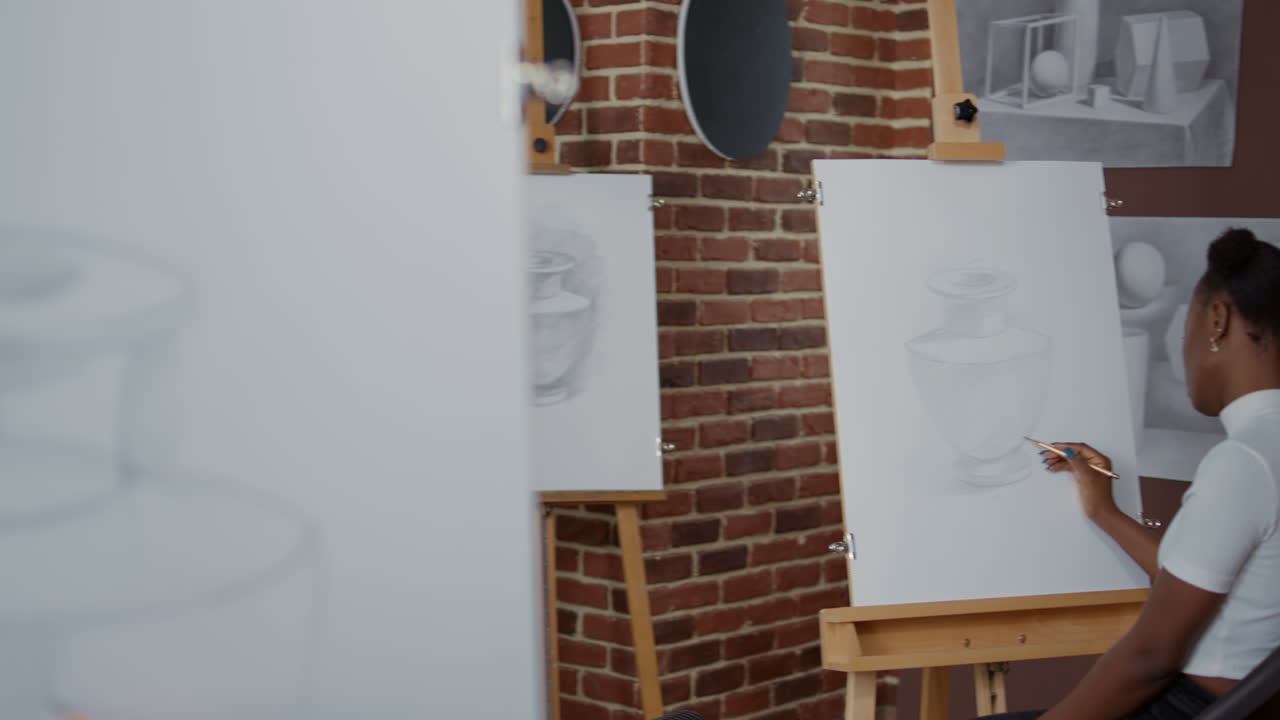 Senior artist teaching diverse group of students drawing skills