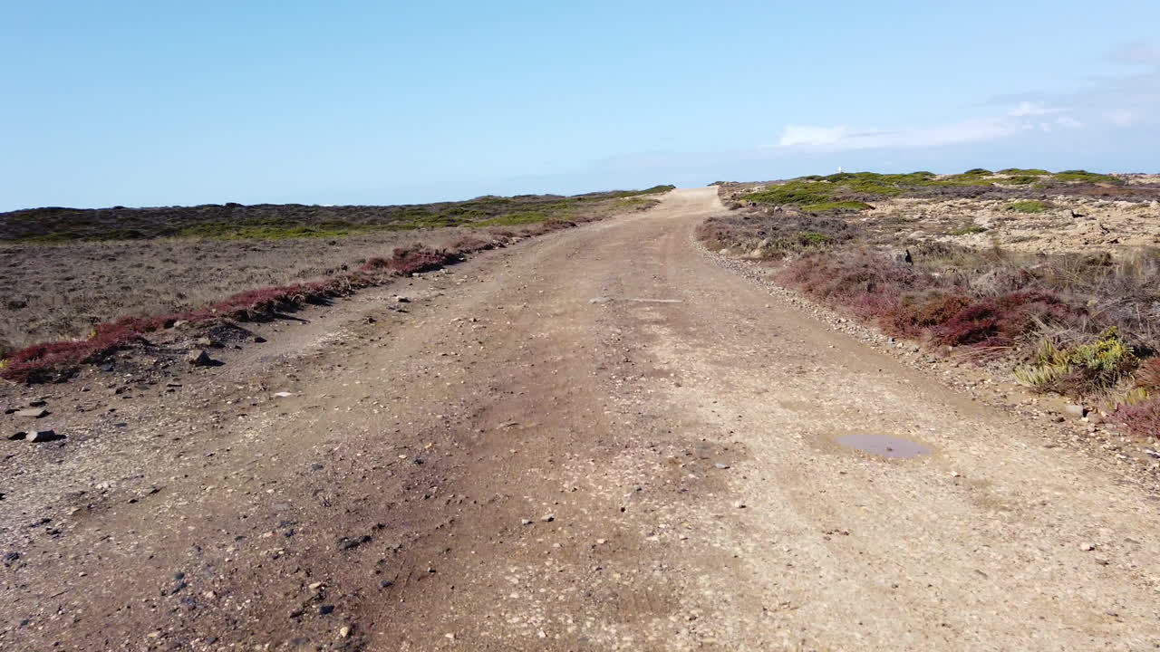 driving on a dusty coast road at the algarve in portugal