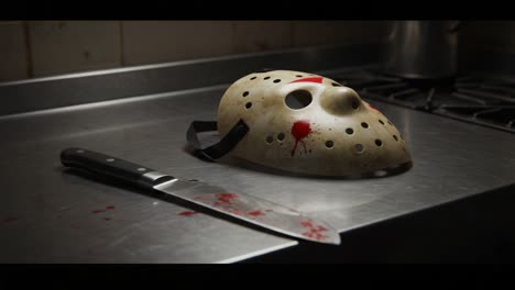 a chilling scene unfolds in a dimly lit kitchen featuring a blood-stained mask and knife, invoking a sense of horror and suspense as the viewer contemplates the sinister events that occurred