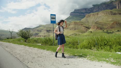 woman at a bus stop in the mountains