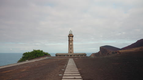 Camera-moving-towards-the-Lighthouse-of-Ponta-dos-Capelinhos-in-the-Volcanic-Portuguese-Islands-of-Faial-in-the-Azores,-North-Atlantic-Ocean,-Portugal