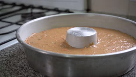 carrot cake batter in a tube pan ready for baking