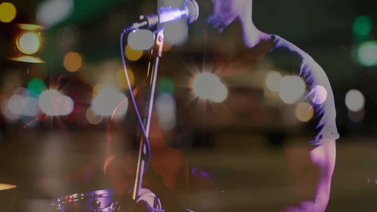 Male street musician playing guitar on sidewalk with mic, with soundwave overlay boosting business