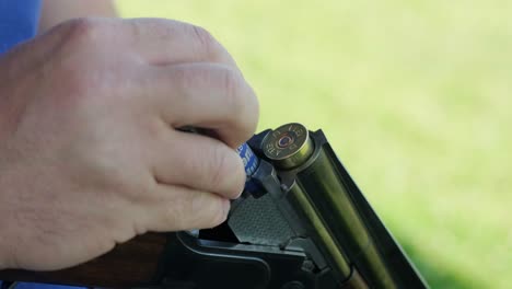 sportsman shoots from a double-barreled shotgun, a sports field for a shooting test is shooting at flying skeet