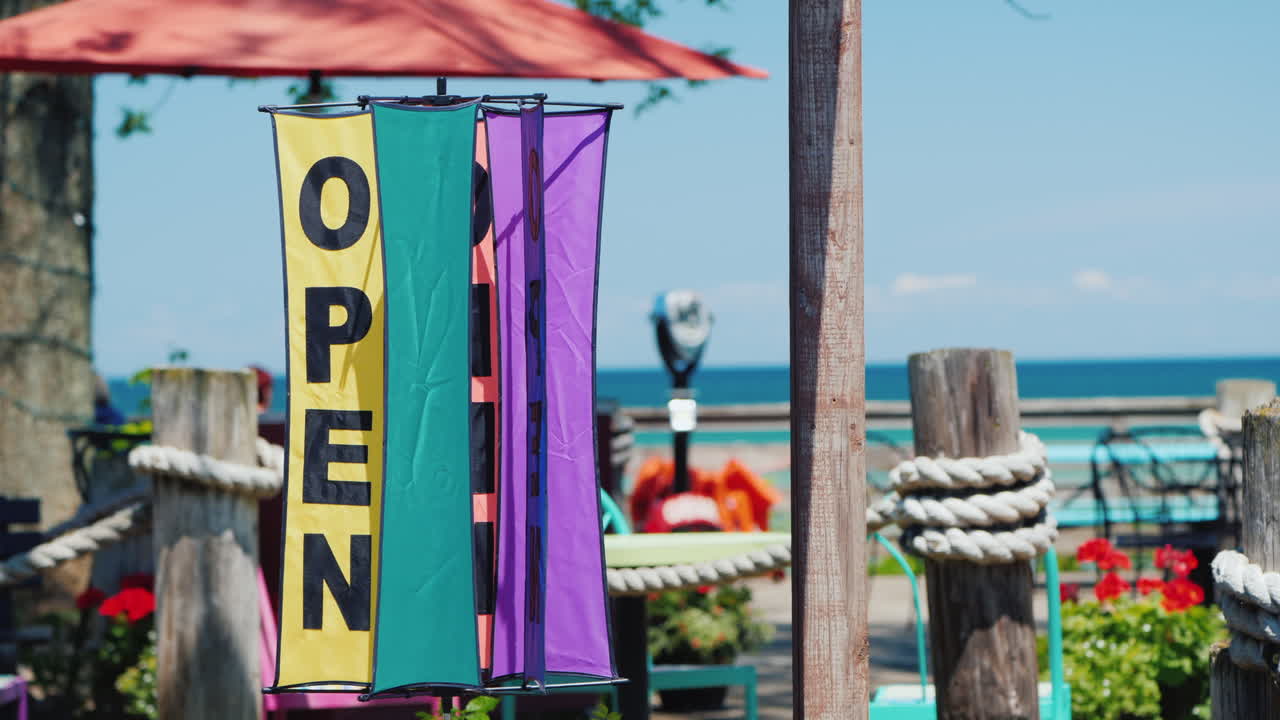 바다와 여름 카페를 배경으로 회전하는 풍향계에 새겨진 비문