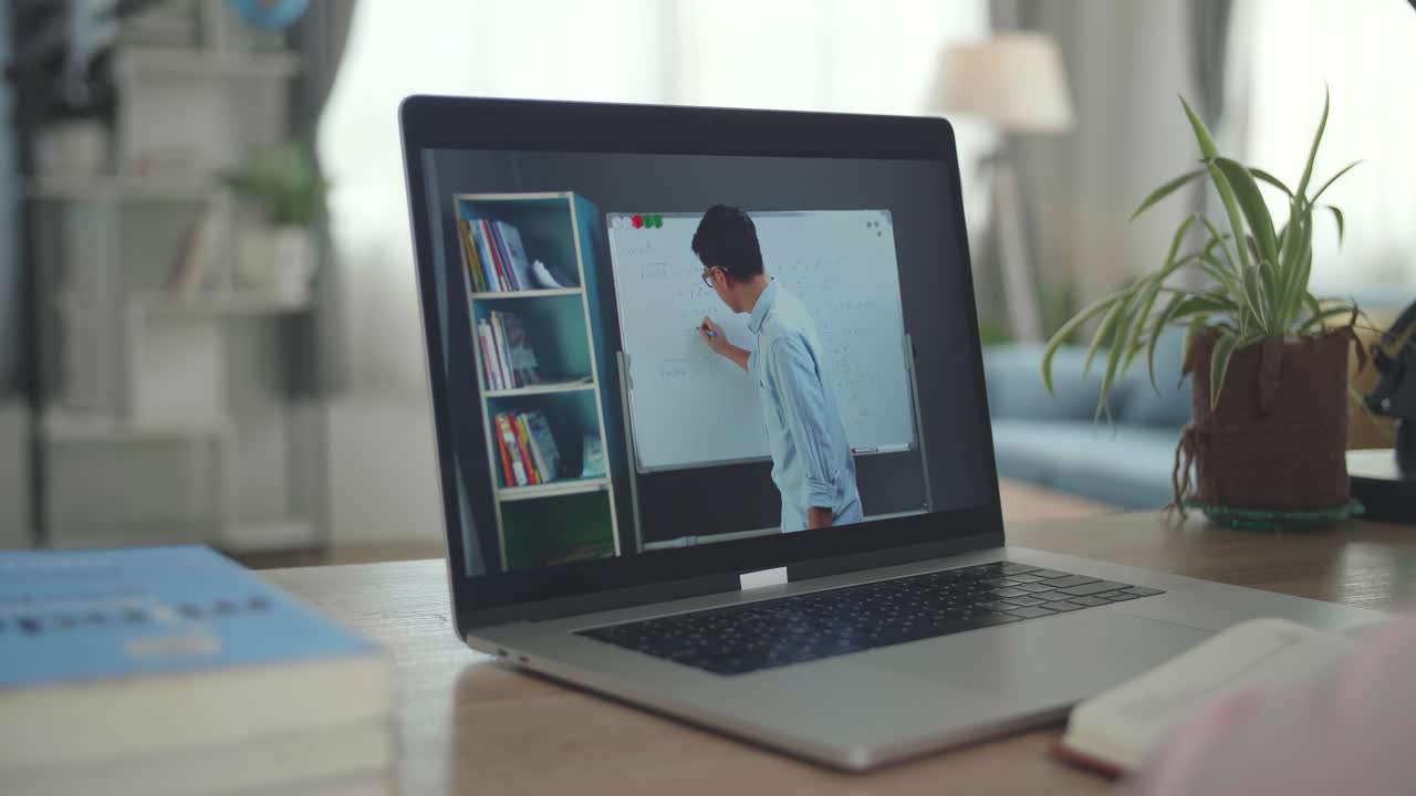 School Teen Girl Student Distance Learning With Online Teacher On Computer Screen. Web Tutor Gives Remote Class Teaching Teenage Pupil Elearning From Home. Over Shoulder Close Up View