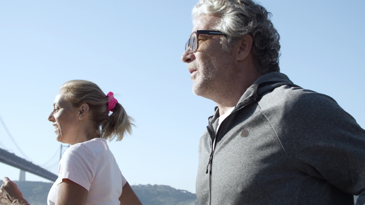Cropped sporty man and woman running outdoors together