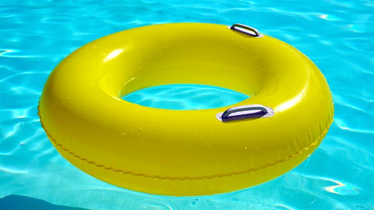 Swimming pool with a brightly yellow inflatable ring
