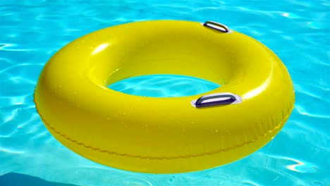 swimming pool with a brightly yellow inflatable ring