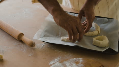 hands shaping homemade pastries