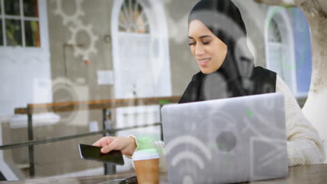 using laptop and smartphone, woman with coffee over technology icons animation