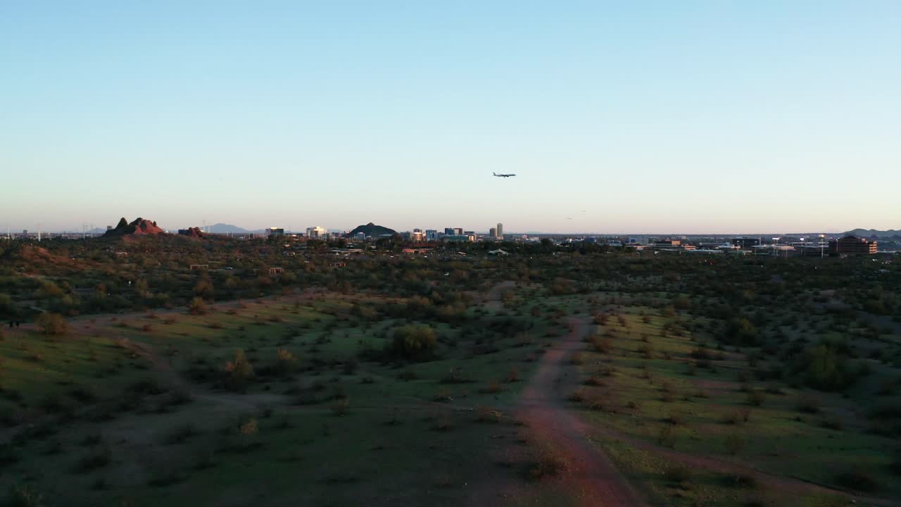 Plane flying over Phoenix, Arizona at sunset.