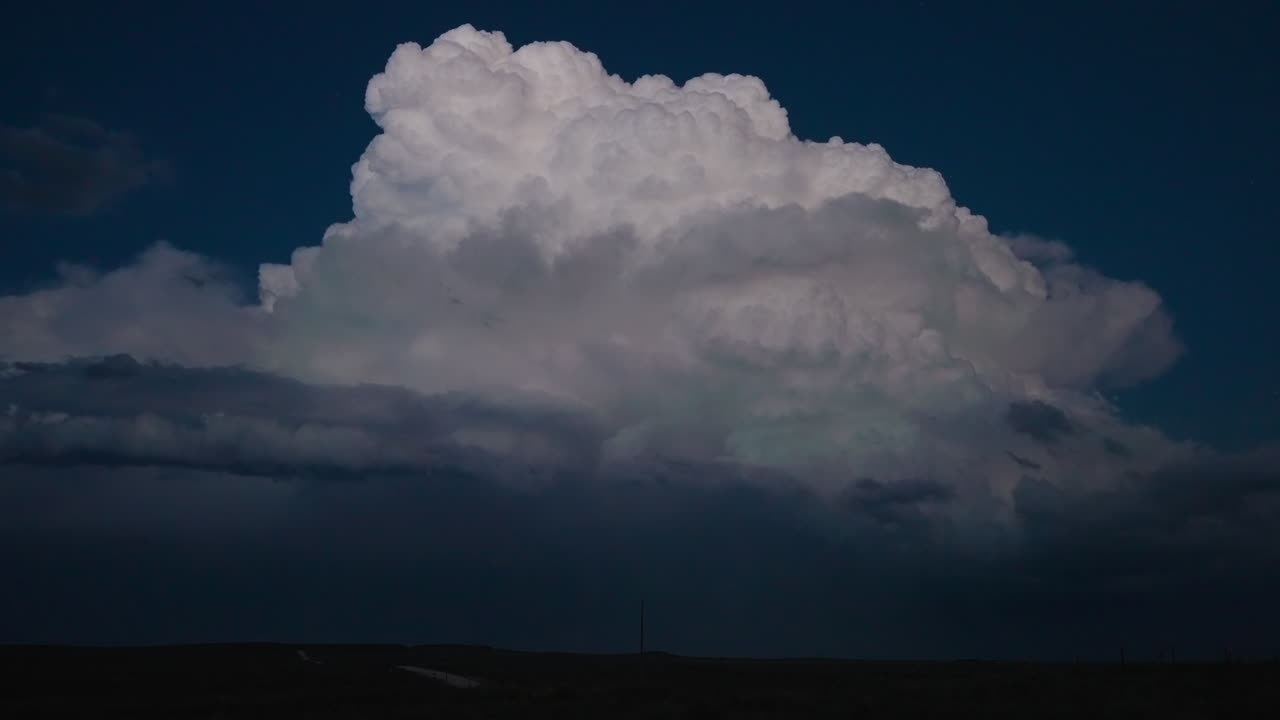 Towering Cumulonimbus Cloud Over Rural Landscape