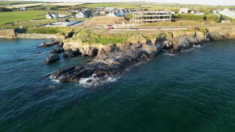 A man is angling from cliffs, an aerial view over rugged coast of Ireland in county Cork
