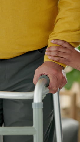 an elderly man is being helped to walk by a caregiver.