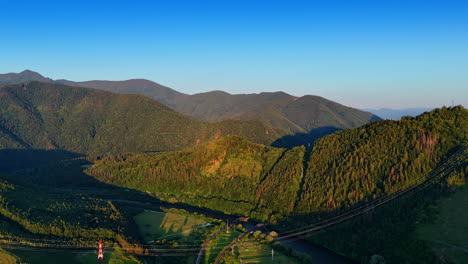 spectacular tatra mountains lit by the setting sun. electric power lines are set along the rocks. slovakia nature. aerial view