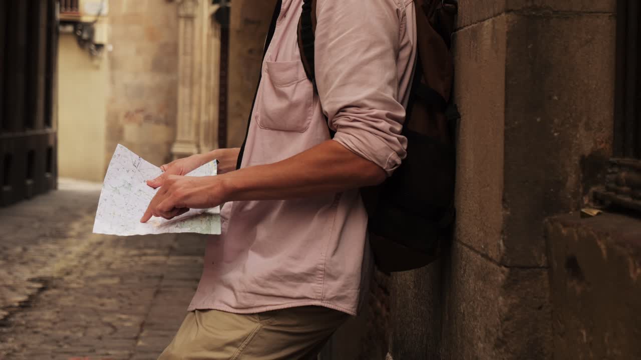 Man tourist using smart phone searching location in map application online close up macro. Backpacker using GPS to find destination on vacation. City or Forest hiking, walking in europe