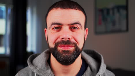 middle eastern caucasian man smiling and looking at the camera - close up shot